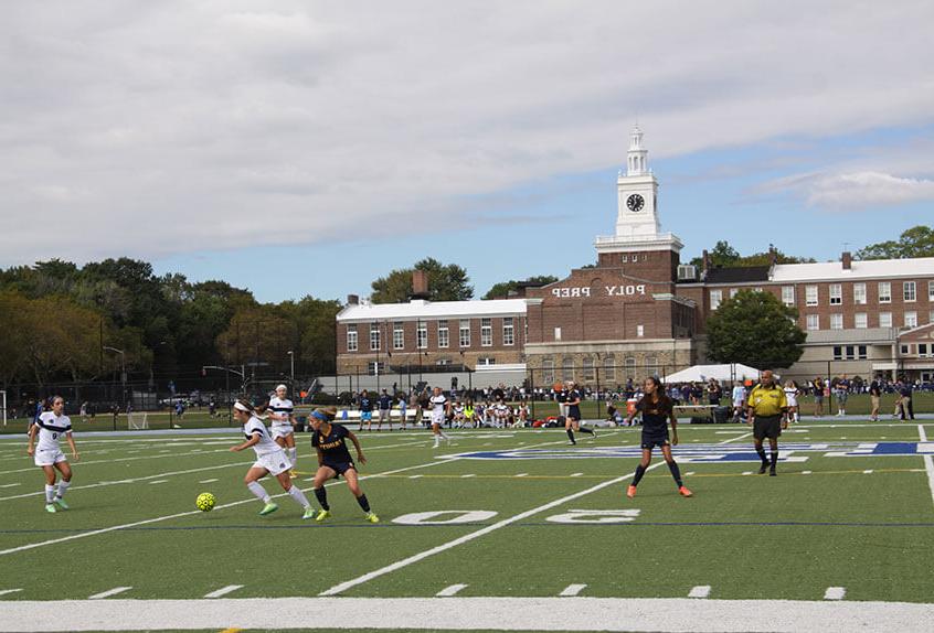 Poly Varsity Girls Soccer team playing on the main field